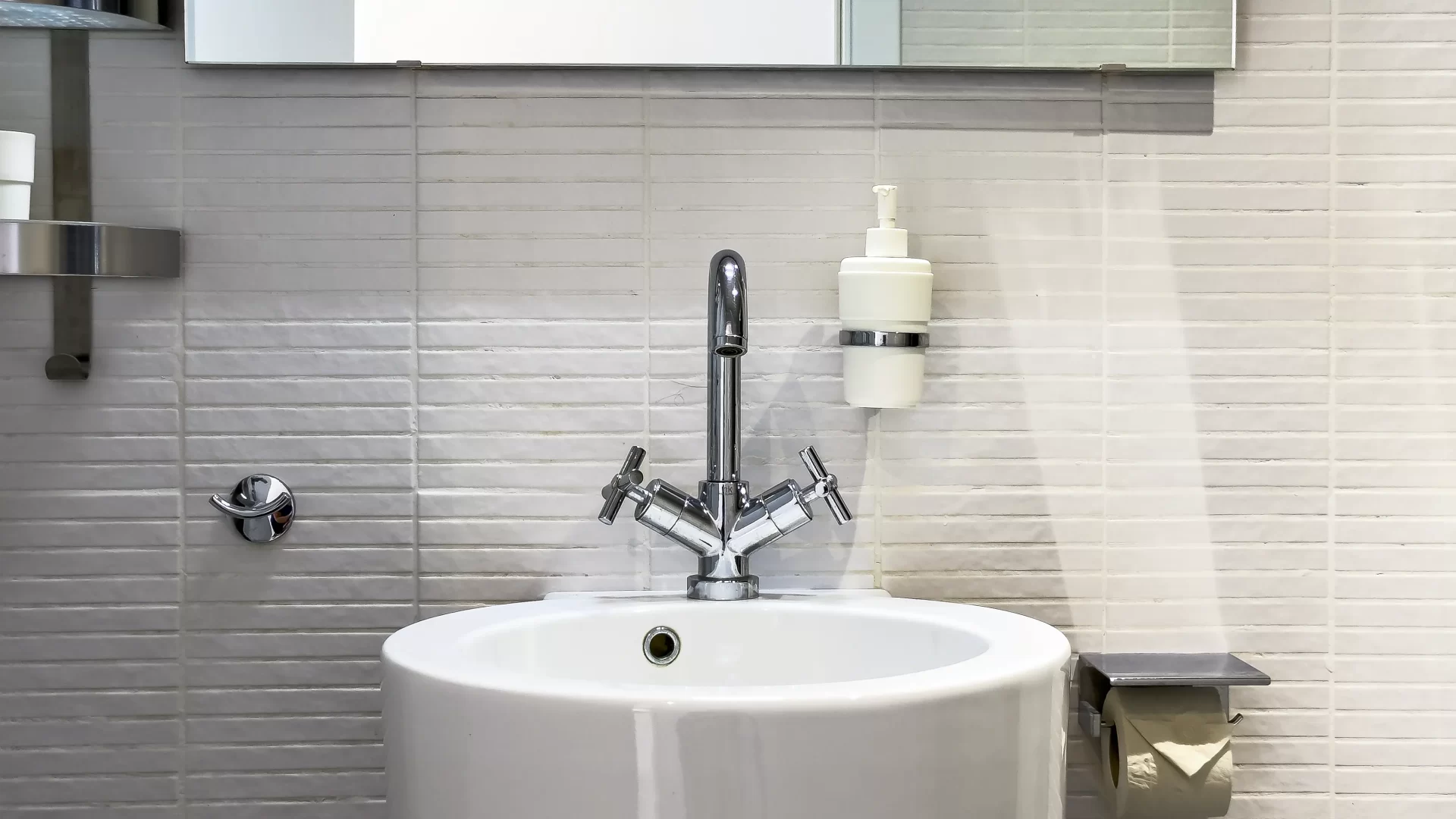 Washing basin with a water tap and hand soap dispenser
