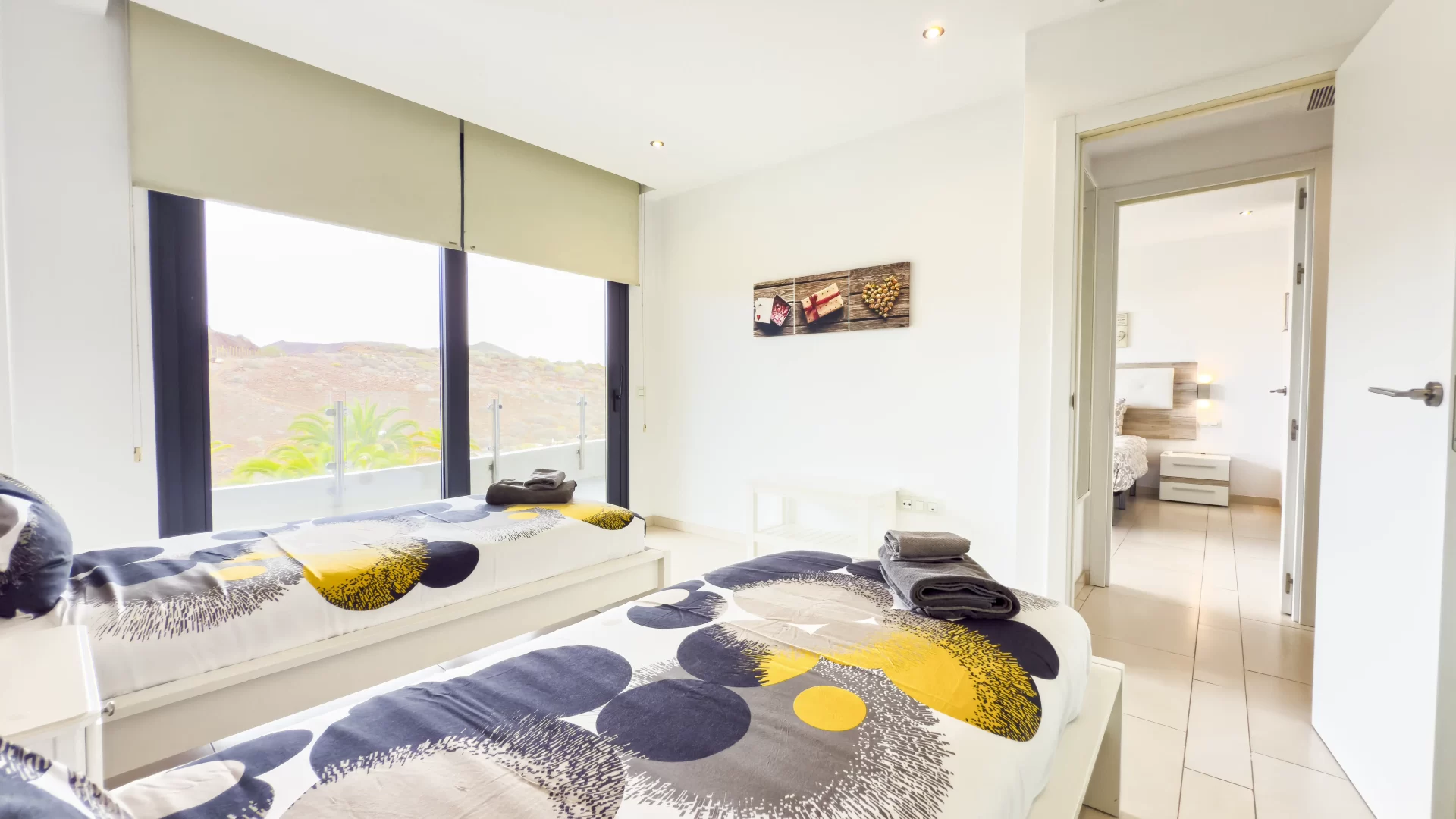 Bedroom with two single beds and terrace with view