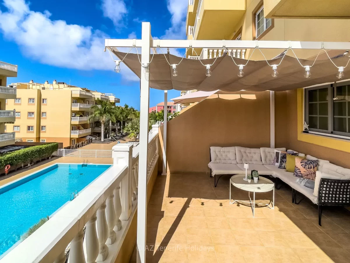 Sunny terrace with pool views at Tenerife Relax Apartment