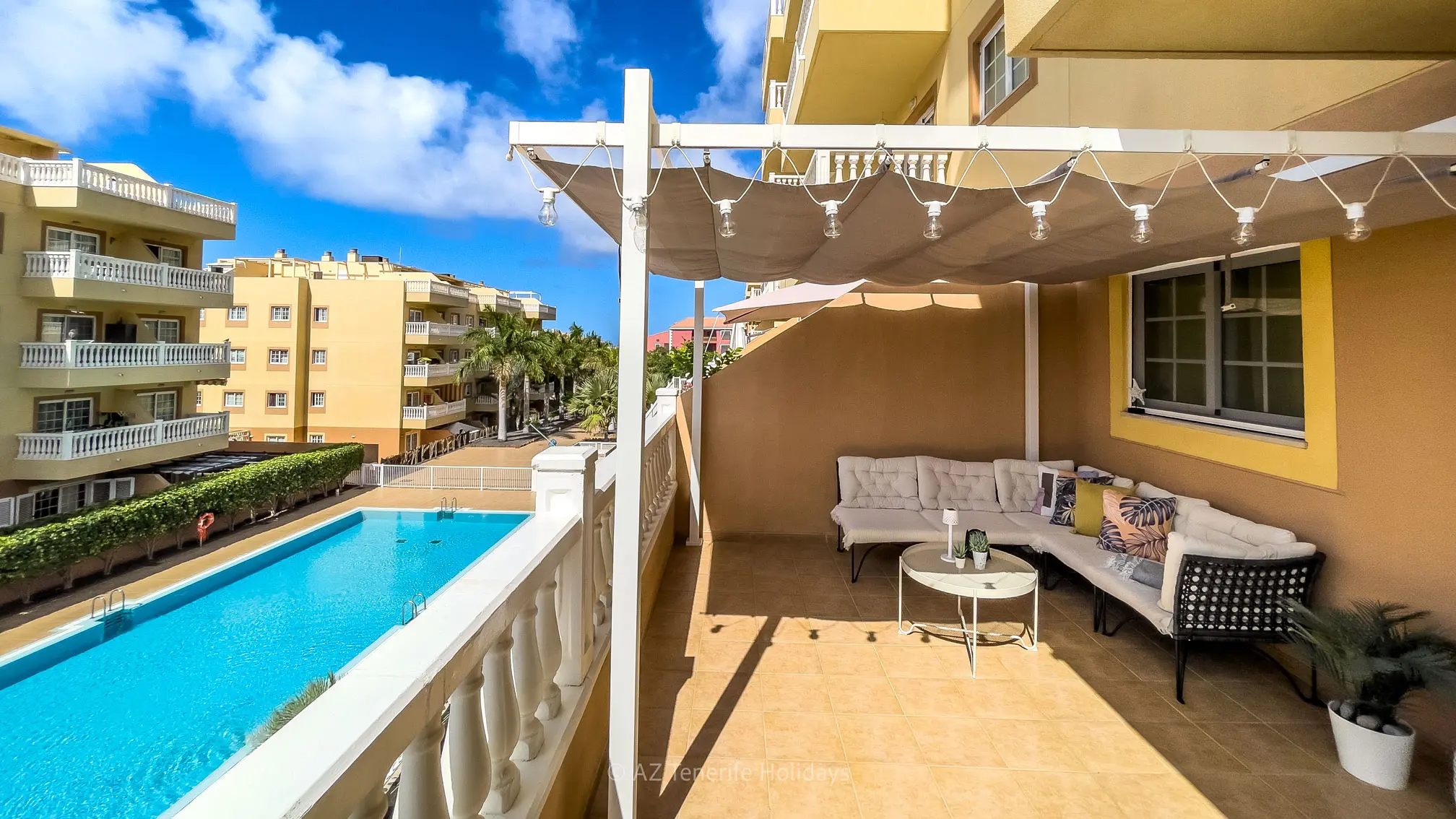 Sunny terrace with pool views at Tenerife Relax Apartment